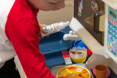 Kids using Truce All-Purpose Cleaner to clean their kitchen toys